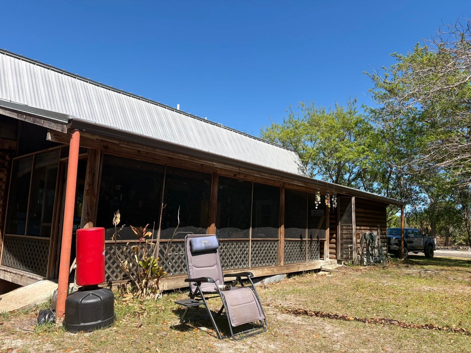 Seamless gutters and custom downspout on a rustic Brevard County cabin