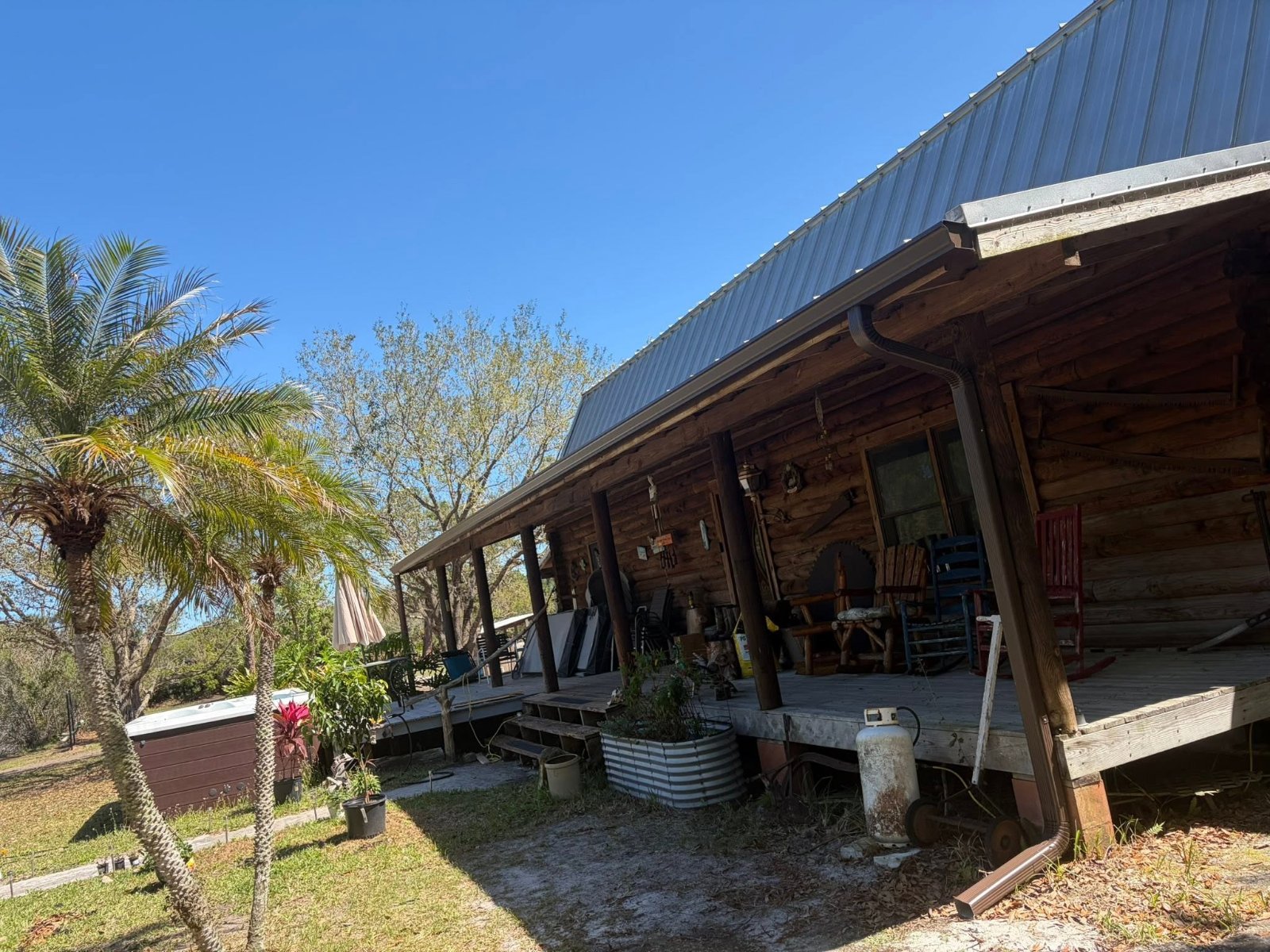 Log home with palm trees and seamless gutters